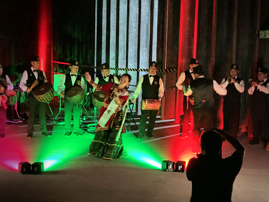 A traditional Nepali band playing in the wind tunnel structure.